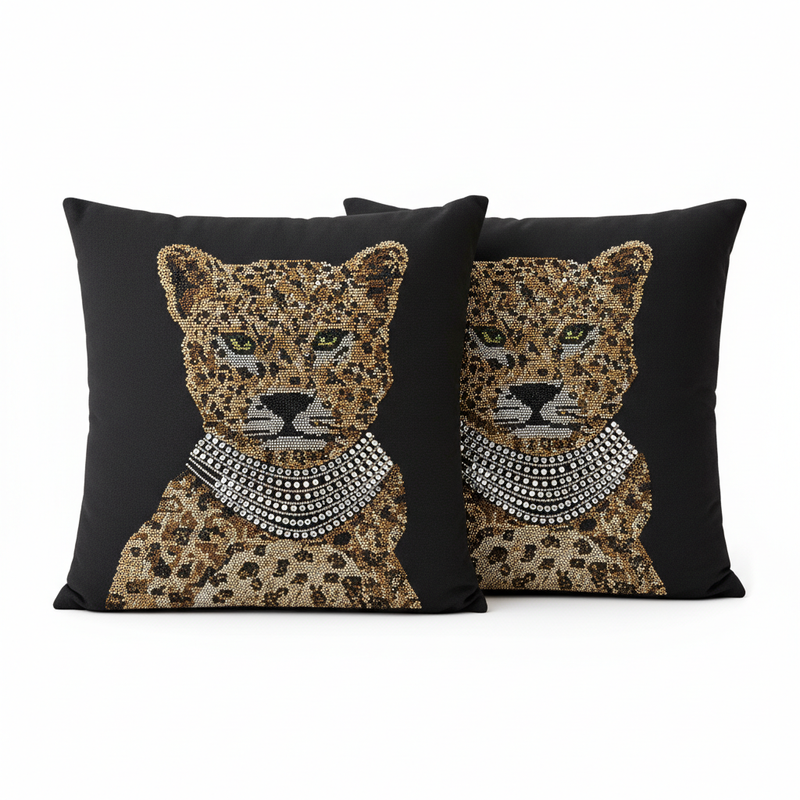 Two decorative pillows with leopard designs and beaded necklaces on a black background.