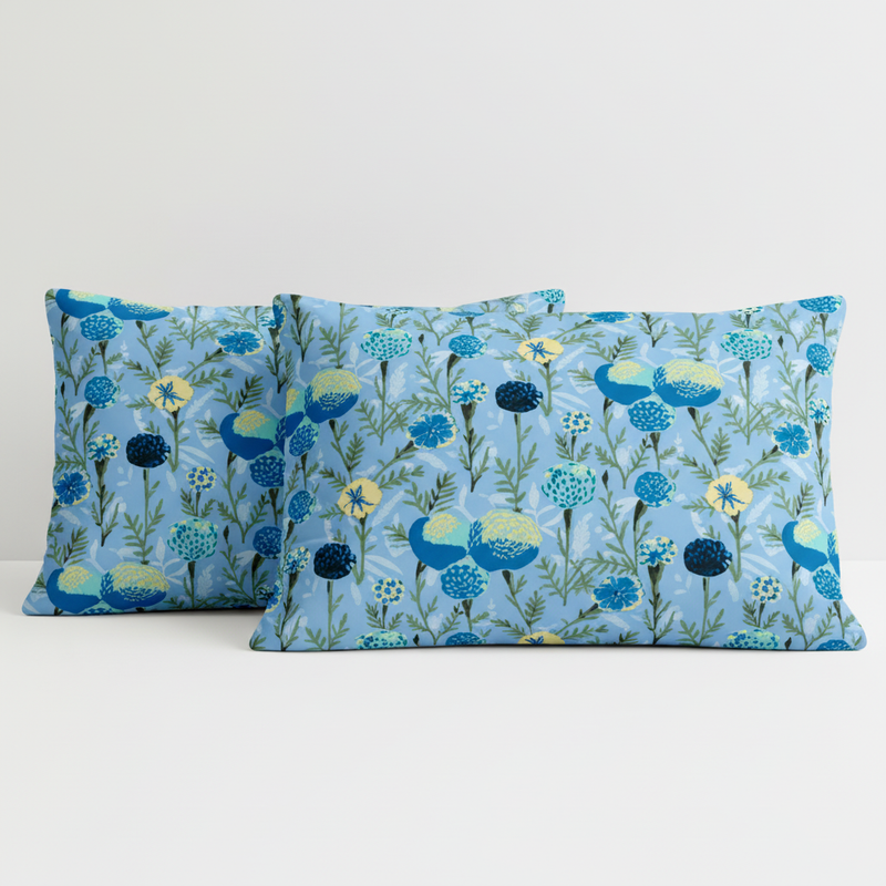 Two blue floral patterned pillows on a white background