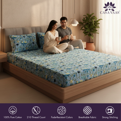 Couple sitting on a bed with a floral mattress cover, Casa Vaas brand visible