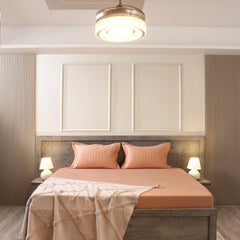Modern bedroom with a bed, headboard, and decorative pillows.