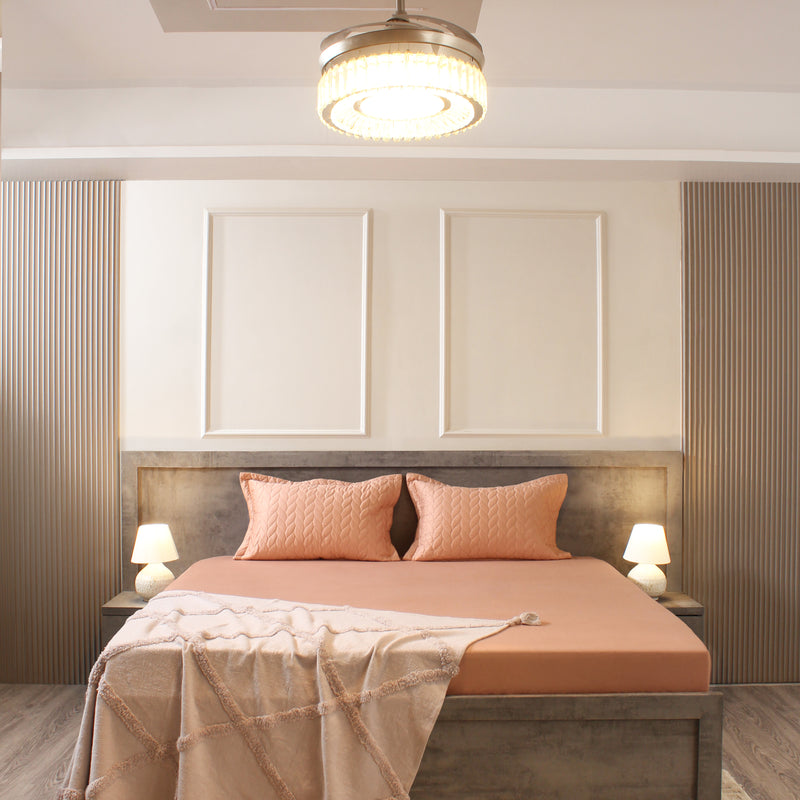 Modern bedroom with a bed, headboard, and decorative pillows.