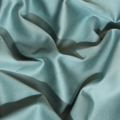 Close-up of textured light blue fabric with folds