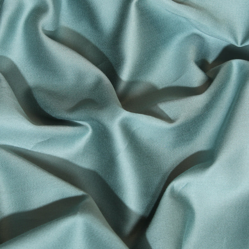 Close-up of textured light blue fabric with folds
