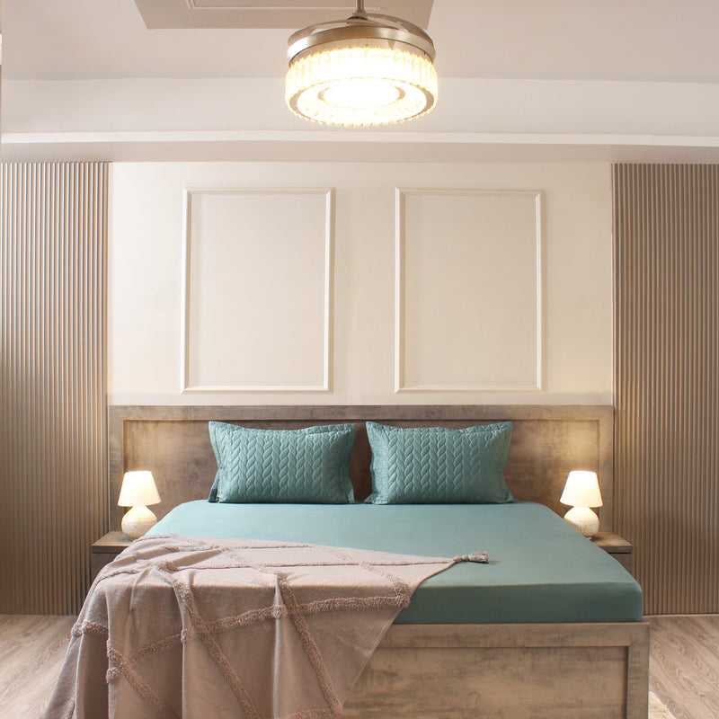 Modern bedroom with wooden headboard, teal bedding, and decorative pillows.