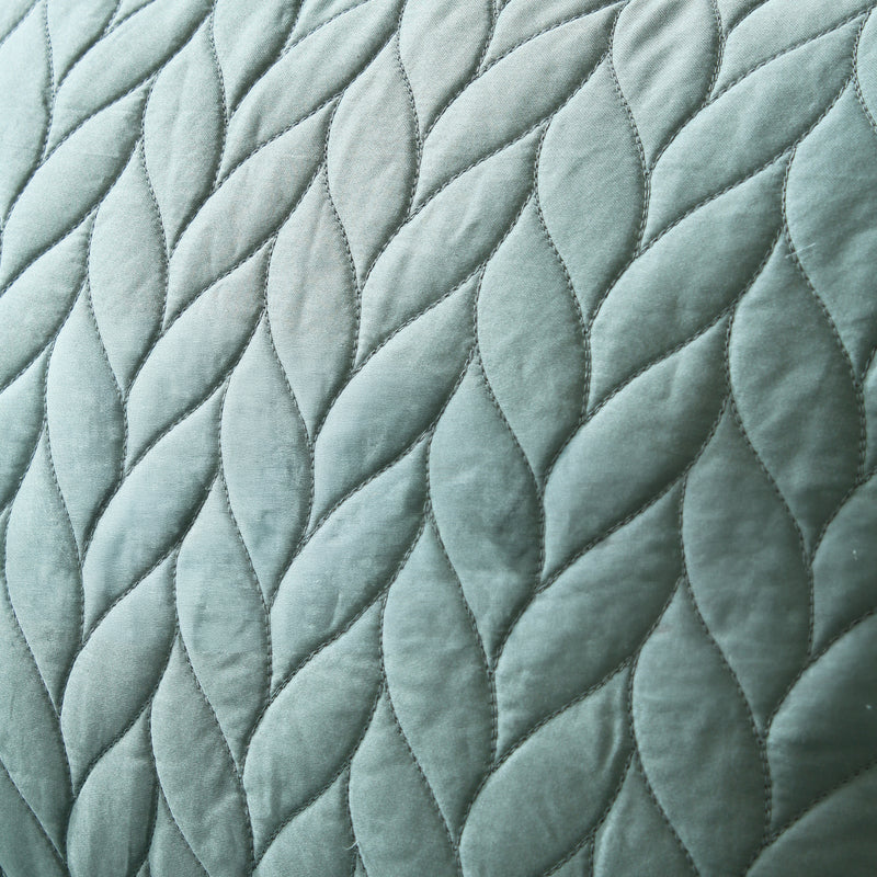 Close-up of textured quilted fabric with diamond pattern