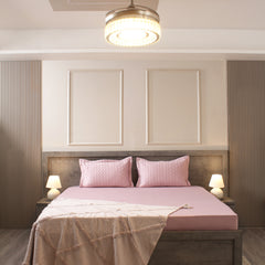 Modern bedroom with pink bedding and wooden headboard