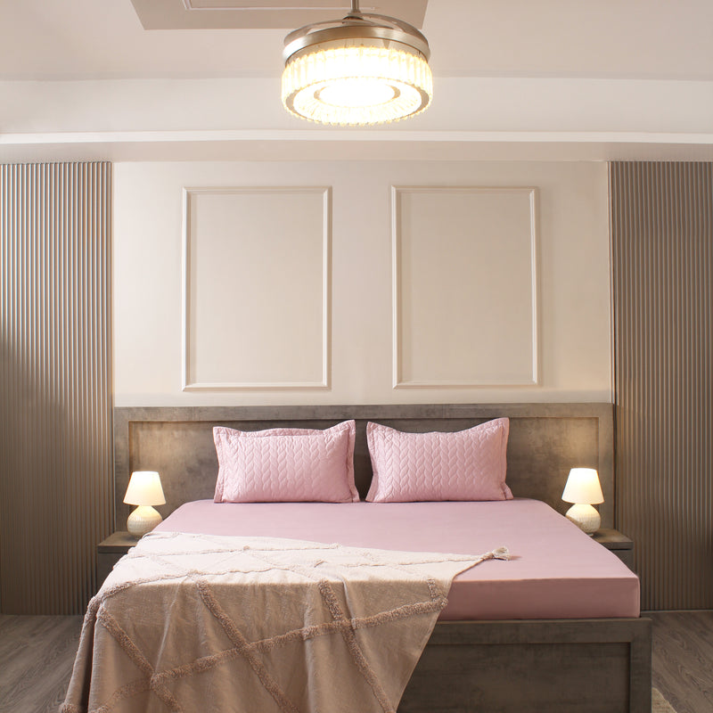 Modern bedroom with pink bedding and wooden headboard