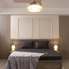 Modern bedroom with a bed, headboard, and ceiling light fixture.