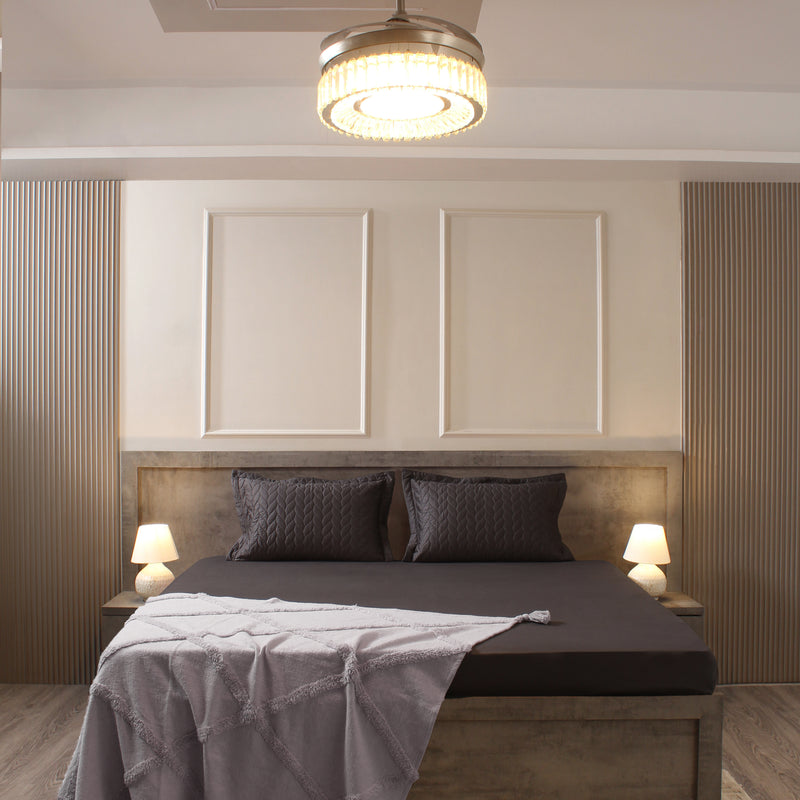 Modern bedroom with a bed, headboard, and ceiling light fixture.