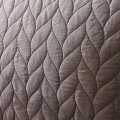 Close-up of quilted fabric with braided pattern