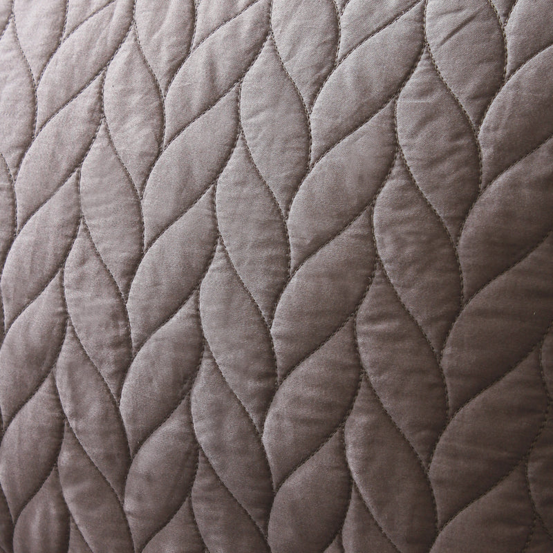 Close-up of quilted fabric with braided pattern