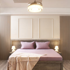 Modern bedroom with a bed, nightstands, and decorative pillows.