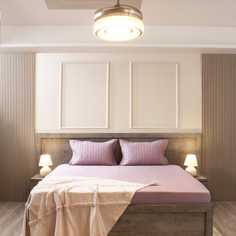 Modern bedroom with a bed, nightstands, and decorative pillows.
