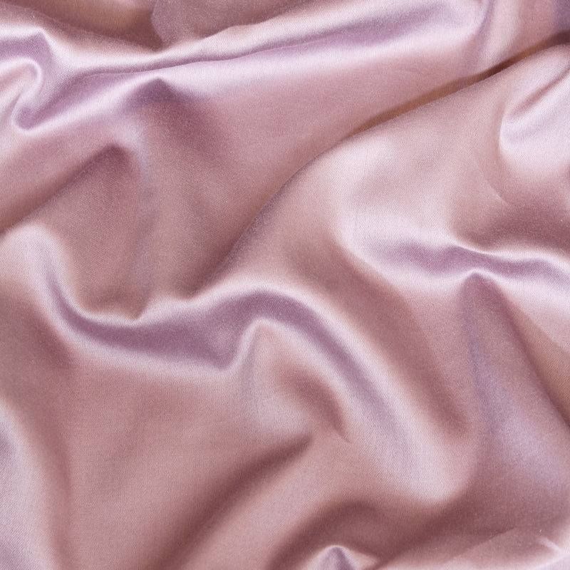 Close-up of pink satin fabric with folds