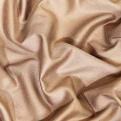 Close-up of beige satin fabric with folds