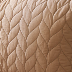 Close-up of a quilted beige fabric with a diamond pattern