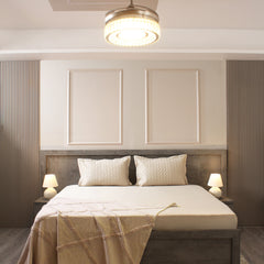 Modern bedroom with a bed, headboard, and ceiling light fixture.