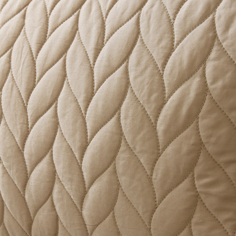 Close-up of beige quilted fabric texture