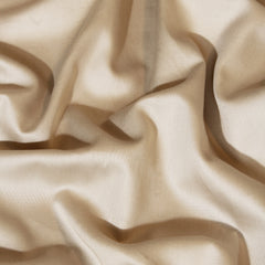 Close-up of beige fabric with folds