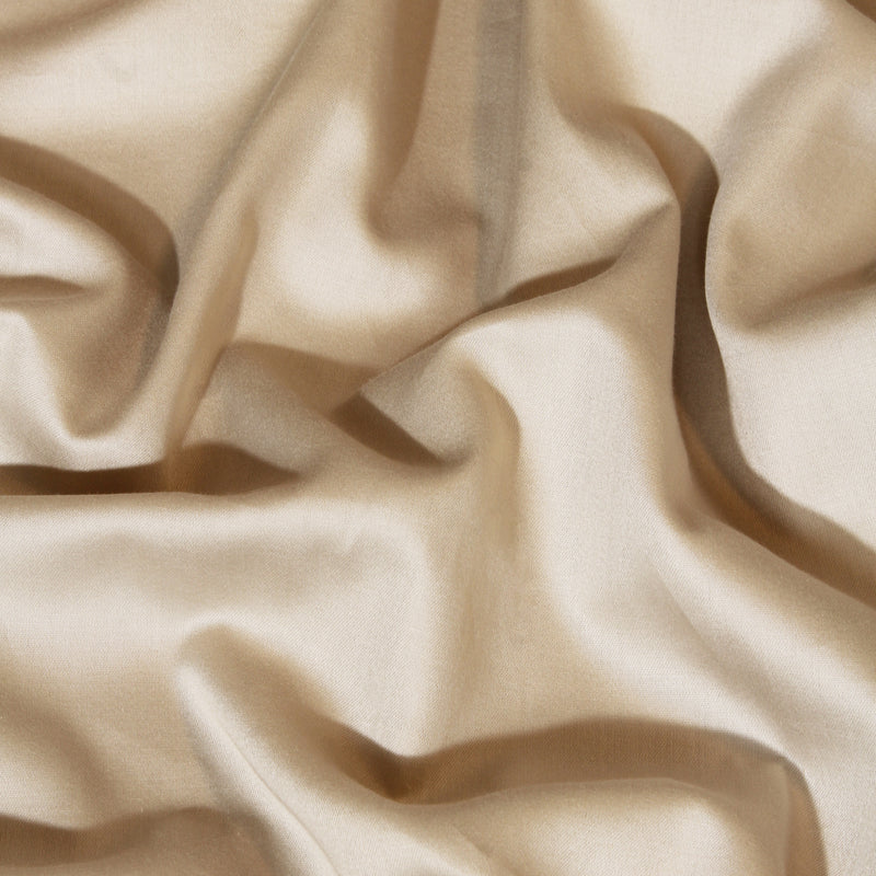 Close-up of beige fabric with folds