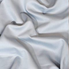 Close-up of light gray fabric with folds