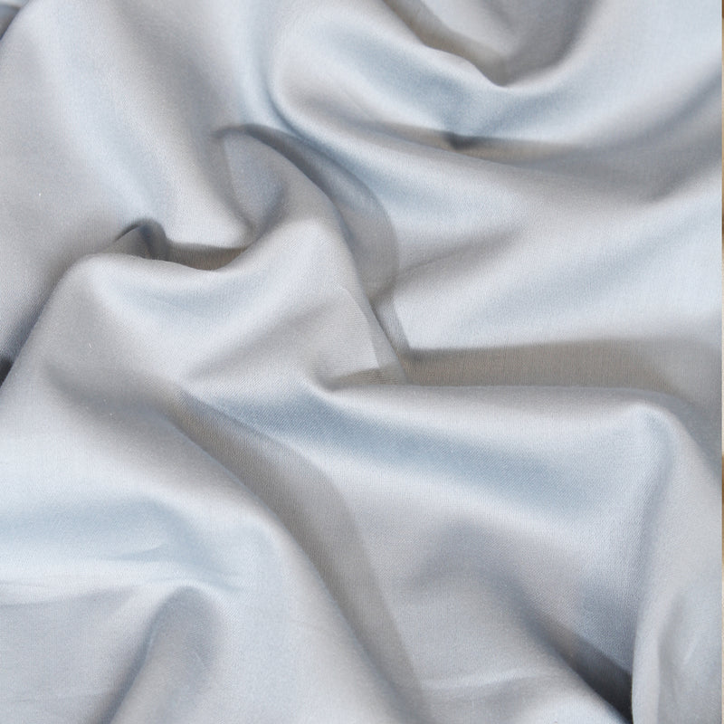 Close-up of light gray fabric with folds
