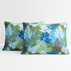 Two decorative pillows with a floral pattern on a white background