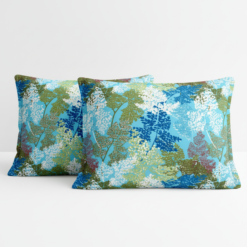 Two decorative pillows with a floral pattern on a white background