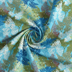 Close-up of a fabric with a floral pattern in blue, green, and white.