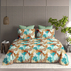 Floral patterned bedspread on a bed with matching pillows in a bedroom setting.