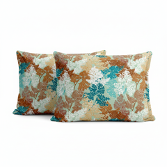Two decorative pillows with a floral pattern on a white background