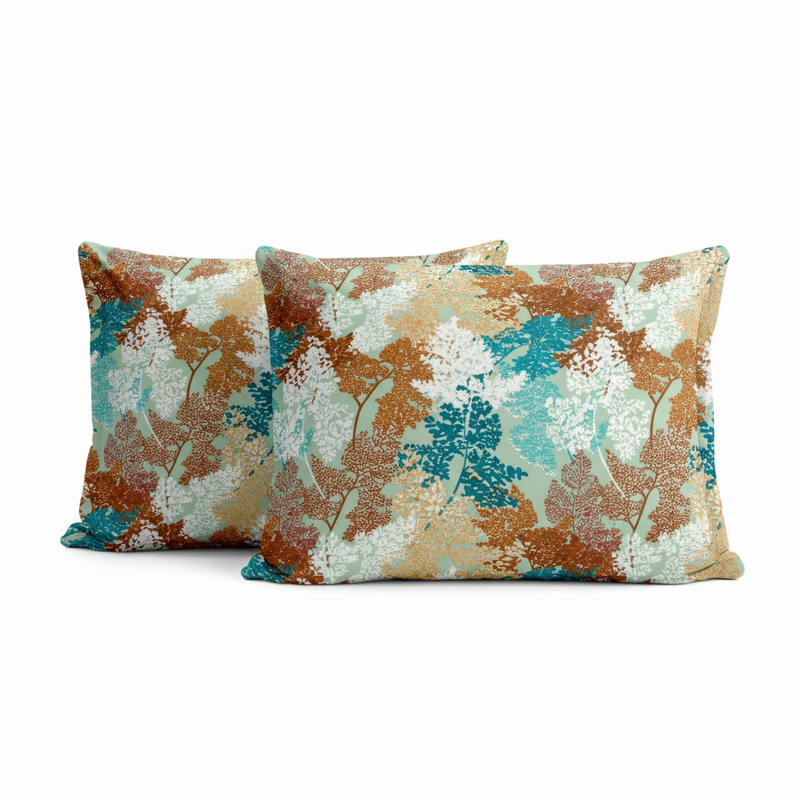 Two decorative pillows with a floral pattern on a white background