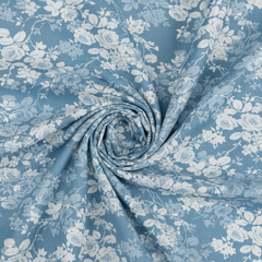 Roll of blue floral fabric with white flowers