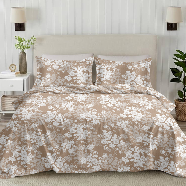 Floral duvet set on a bed in a bedroom with lamps and plants.