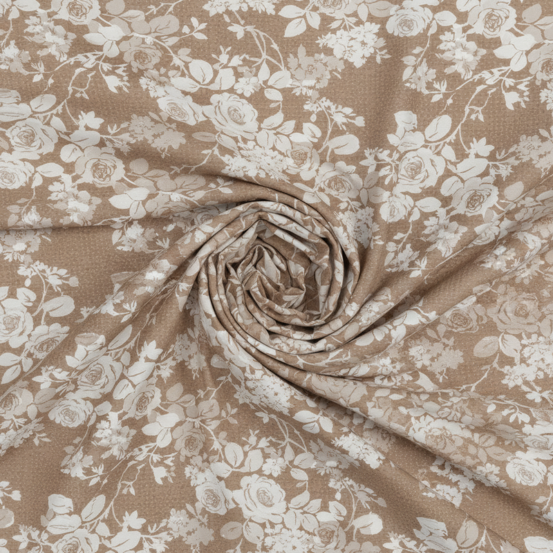 Roll of fabric with beige and white floral pattern