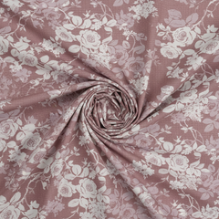 Roll of pink floral fabric with white flowers