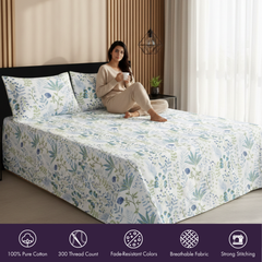 Woman sitting on a bed with floral bedding in a bedroom setting
