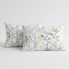 Two decorative pillows with floral patterns on a light gray background