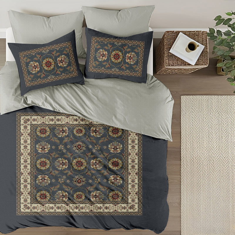 Decorative bedspread with floral patterns on a bed in a bedroom setting.