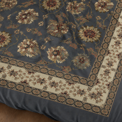 Close-up of a patterned rug with floral designs on a dark background