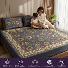 Woman and child sitting on a bed with floral patterned bedding