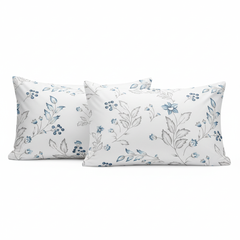 Two white pillows with blue floral patterns on a white background