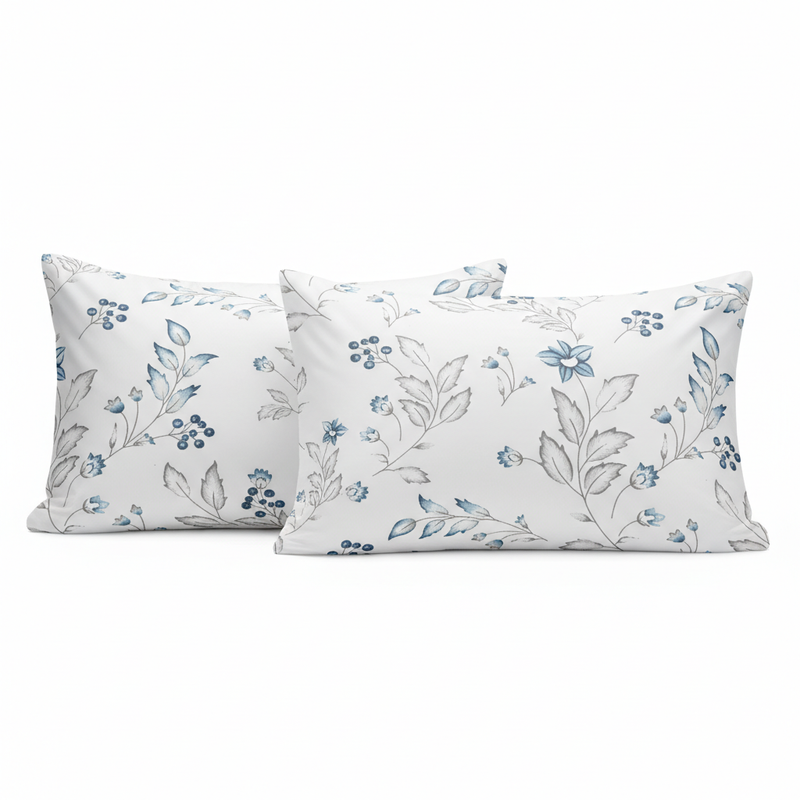 Two white pillows with blue floral patterns on a white background