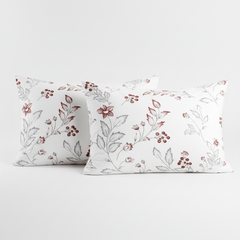 Two floral-patterned pillows on a white background