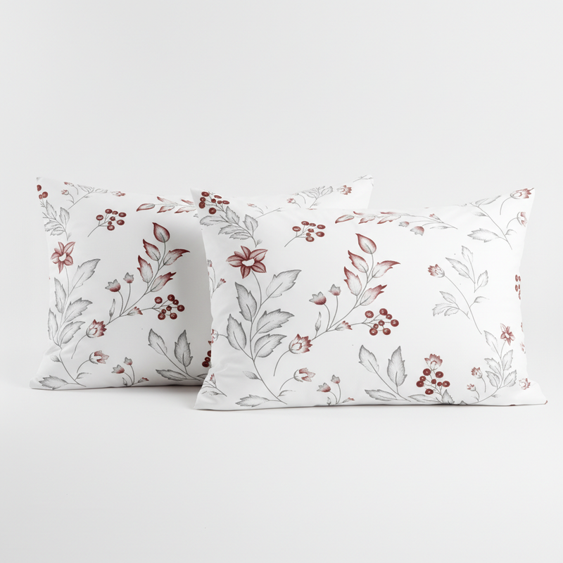 Two floral-patterned pillows on a white background