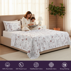 Woman and child reading on a bed with floral bedding in a bright bedroom.