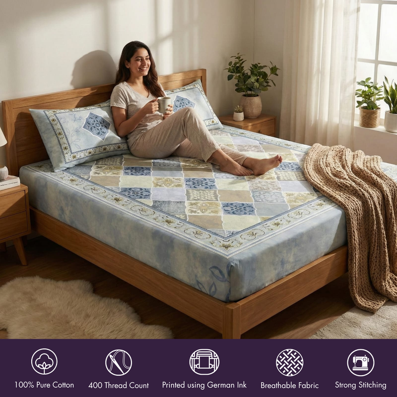 Woman sitting on a bed with floral bedding in a cozy bedroom.