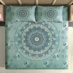Mandala patterned bedspread with matching pillows on a bed.