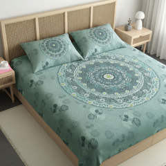 Bed with green patterned bedding and pillows in a bedroom setting.