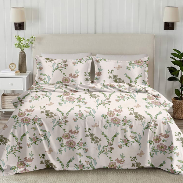 Floral bedding set on a bed in a bedroom with lamps and plants.